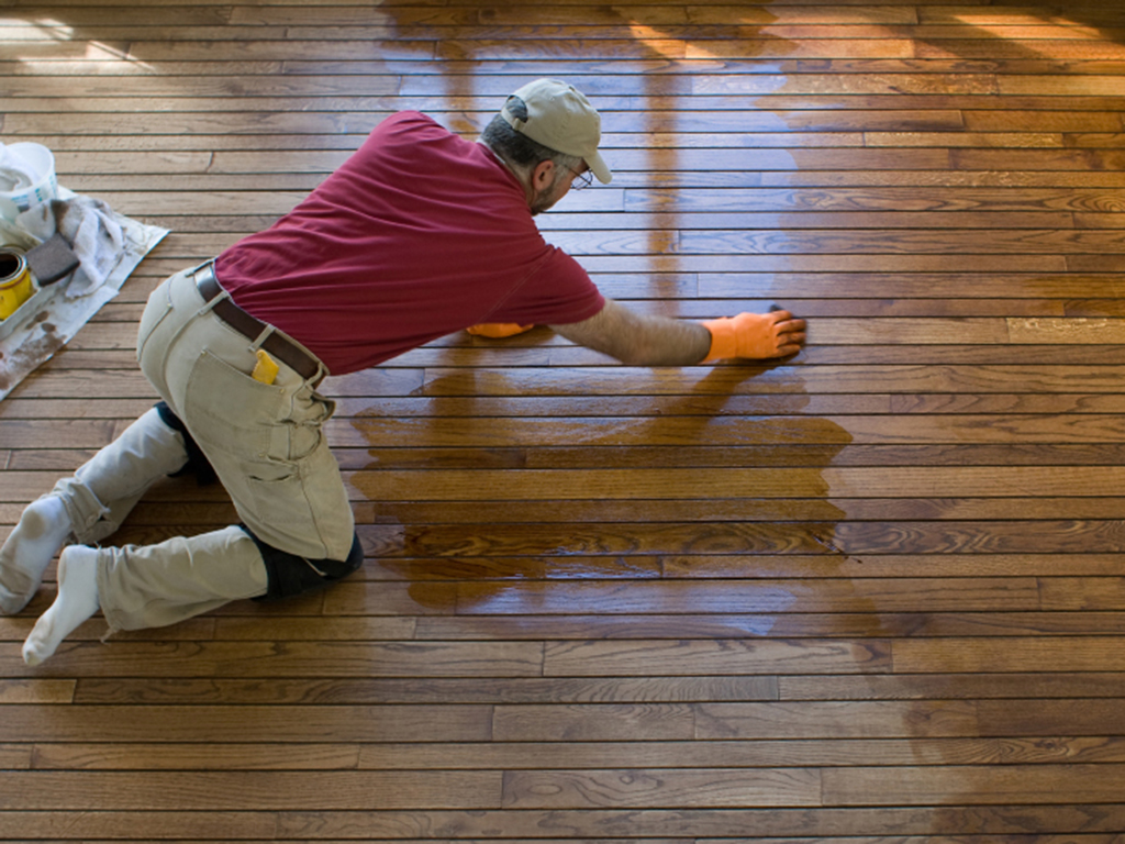 A north versailles fabulous floors technician refinishing a hardwood floor